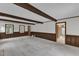 Living room featuring brick fireplace, wood beams, and natural light at 8121 Bentwood Pl, Raleigh, NC 27615
