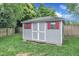 Storage shed with red trim and double doors at 8121 Bentwood Pl, Raleigh, NC 27615