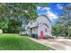 Side exterior featuring gray siding, red door, and driveway at 8121 Bentwood Pl, Raleigh, NC 27615