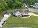 An aerial view of the property showcasing its well-maintained landscaping, detached garage, and inviting curb appeal at 817 Mossy Oak Dr, Fuquay Varina, NC 27526