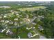 An aerial view shows a nice neighborhood, proximity to downtown Fuquay, with lush greenery and well-maintained homes at 817 Mossy Oak Dr, Fuquay Varina, NC 27526