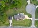 An aerial view shows a home with an expansive manicured lawn, detached garage, and outdoor patio at 817 Mossy Oak Dr, Fuquay Varina, NC 27526