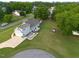 Back aerial view features a charming backyard patio, green space, and an attached garage in a Gathering-friendly neighborhood at 817 Mossy Oak Dr, Fuquay Varina, NC 27526