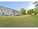 Spacious backyard with lush green grass, playground, and patio area at 817 Mossy Oak Dr, Fuquay Varina, NC 27526