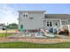 Backyard patio area with chairs, slide, and ample space for relaxation at 817 Mossy Oak Dr, Fuquay Varina, NC 27526