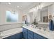 Bathroom featuring double sink, tub and large window at 817 Mossy Oak Dr, Fuquay Varina, NC 27526