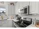 This kitchen has white cabinets, subway tile backsplash, stainless steel appliances and quartz countertops at 817 Mossy Oak Dr, Fuquay Varina, NC 27526