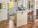 This kitchen is equipped with hardwood floors, an island with seating and stainless steel appliances at 817 Mossy Oak Dr, Fuquay Varina, NC 27526