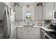 This kitchen has white cabinets, subway tile backsplash, stainless steel appliances and quartz countertops at 817 Mossy Oak Dr, Fuquay Varina, NC 27526