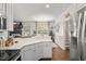 Bright kitchen with an open concept, stainless steel appliances, lots of natural light and hardwood floors at 817 Mossy Oak Dr, Fuquay Varina, NC 27526