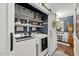Convenient laundry room featuring a modern washer and dryer, custom shelving, and stylish sliding barn doors at 817 Mossy Oak Dr, Fuquay Varina, NC 27526