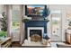 A fireplace is the focal point of this living room, complemented by elegant decor and natural light at 817 Mossy Oak Dr, Fuquay Varina, NC 27526