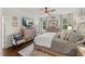 Comfortable main bedroom suite with a decorative rug, lots of natural light, neutral paint and hardwood floors at 817 Mossy Oak Dr, Fuquay Varina, NC 27526