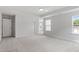Bright bedroom with carpet, windows, and tray ceiling detail at 84 Black Walnut Dr # 200, Garner, NC 27529