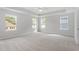 Spacious bedroom featuring multiple windows and plush carpeting at 84 Black Walnut Dr # 200, Garner, NC 27529