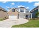 Attractive two-story home with a three-car garage, brick and white siding, and a curving driveway at 84 Black Walnut Dr # 200, Garner, NC 27529