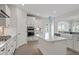Modern kitchen boasts stainless appliances, white cabinets, a center island, and hardwood flooring at 84 Black Walnut Dr # 200, Garner, NC 27529