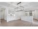Elegant dining area and kitchen featuring hardwood floors, a decorative light fixture, and modern cabinetry at 84 Black Walnut Dr # 200, Garner, NC 27529