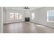 Spacious living room features hardwood floors, a fireplace, and large windows providing ample natural light at 84 Black Walnut Dr # 200, Garner, NC 27529