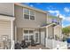 Back patio of townhome featuring comfortable seating, a grilling area, and privacy fence at 886 Cupola Dr, Raleigh, NC 27603