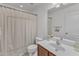 Bathroom features a shower with tub, sink, and large mirror at 886 Cupola Dr, Raleigh, NC 27603