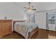 Well-lit bedroom featuring a ceiling fan, wood floors, and a large window at 886 Cupola Dr, Raleigh, NC 27603