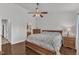This bedroom boasts wood floors, a ceiling fan, and a nearby bathroom at 886 Cupola Dr, Raleigh, NC 27603
