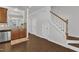 Open hallway features hardwood floors, staircase, and view of the kitchen at 886 Cupola Dr, Raleigh, NC 27603