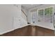 Entry hallway featuring hardwood floors, staircase, and access to front door at 886 Cupola Dr, Raleigh, NC 27603