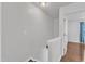 Second story landing features hardwood floors and an open door at 886 Cupola Dr, Raleigh, NC 27603