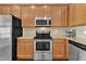 Close up on stainless oven and microwave, granite counters, and wooden cabinets at 886 Cupola Dr, Raleigh, NC 27603