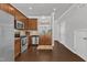 Modern kitchen featuring stainless steel appliances, hardwood floors, and easy access to adjacent living areas at 886 Cupola Dr, Raleigh, NC 27603
