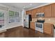 Bright kitchen features stainless appliances, granite counters, and wooden cabinets at 886 Cupola Dr, Raleigh, NC 27603