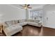 Bright living room showcasing a plush sectional sofa, large window, and hardwood flooring at 886 Cupola Dr, Raleigh, NC 27603