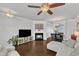 Comfortable living room featuring a fireplace, hardwood floors, and seamless access to the dining space at 886 Cupola Dr, Raleigh, NC 27603