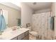 Modern bathroom with shower featuring patterned curtain, single-sink vanity, and ample lighting at 96 Northwood Dr, Fuquay Varina, NC 27526