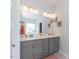 Elegant bathroom featuring a dual-sink vanity, a large mirror, and stylish lighting fixtures at 96 Northwood Dr, Fuquay Varina, NC 27526