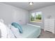 Bedroom showcasing carpet floors, gray walls, white trim, and a bright window with natural light at 96 Northwood Dr, Fuquay Varina, NC 27526