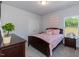 Cozy bedroom featuring carpet floors, light gray walls, a window and an attractive comforter set at 96 Northwood Dr, Fuquay Varina, NC 27526