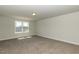 Spacious bonus room with neutral carpet, light gray walls, and a bright window at 96 Northwood Dr, Fuquay Varina, NC 27526
