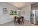 Cozy dining area filled with natural light with adjacent stainless steel refrigerator and wainscoting at 96 Northwood Dr, Fuquay Varina, NC 27526