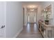 Bright entryway with wood floors, leading to the front door, and a view of the chandelier at 96 Northwood Dr, Fuquay Varina, NC 27526