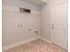 A utility room including tile-style floors, wire shelving, and white walls at 96 Northwood Dr, Fuquay Varina, NC 27526