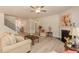 Spacious living room with a fireplace, neutral décor, hardwood floors, and stairway at 96 Northwood Dr, Fuquay Varina, NC 27526