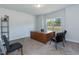Study featuring neutral carpet, light gray walls, a window and a wood desk at 96 Northwood Dr, Fuquay Varina, NC 27526