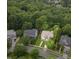 An aerial view highlighting the home's property lines amidst mature trees at 10415 Ashmead Ln, Raleigh, NC 27614