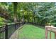 Fenced backyard with lush greenery and landscaping, offering a private outdoor space at 10415 Ashmead Ln, Raleigh, NC 27614