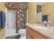 Bright bathroom features a tub with floral shower curtain and a granite-topped vanity with sink at 10415 Ashmead Ln, Raleigh, NC 27614