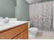 Bathroom featuring green walls, a vanity with sink and cabinet, and a shower/tub combination at 10415 Ashmead Ln, Raleigh, NC 27614