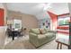 Spacious bedroom features tan carpet, a comfortable sofa, window and a ceiling fan at 10415 Ashmead Ln, Raleigh, NC 27614